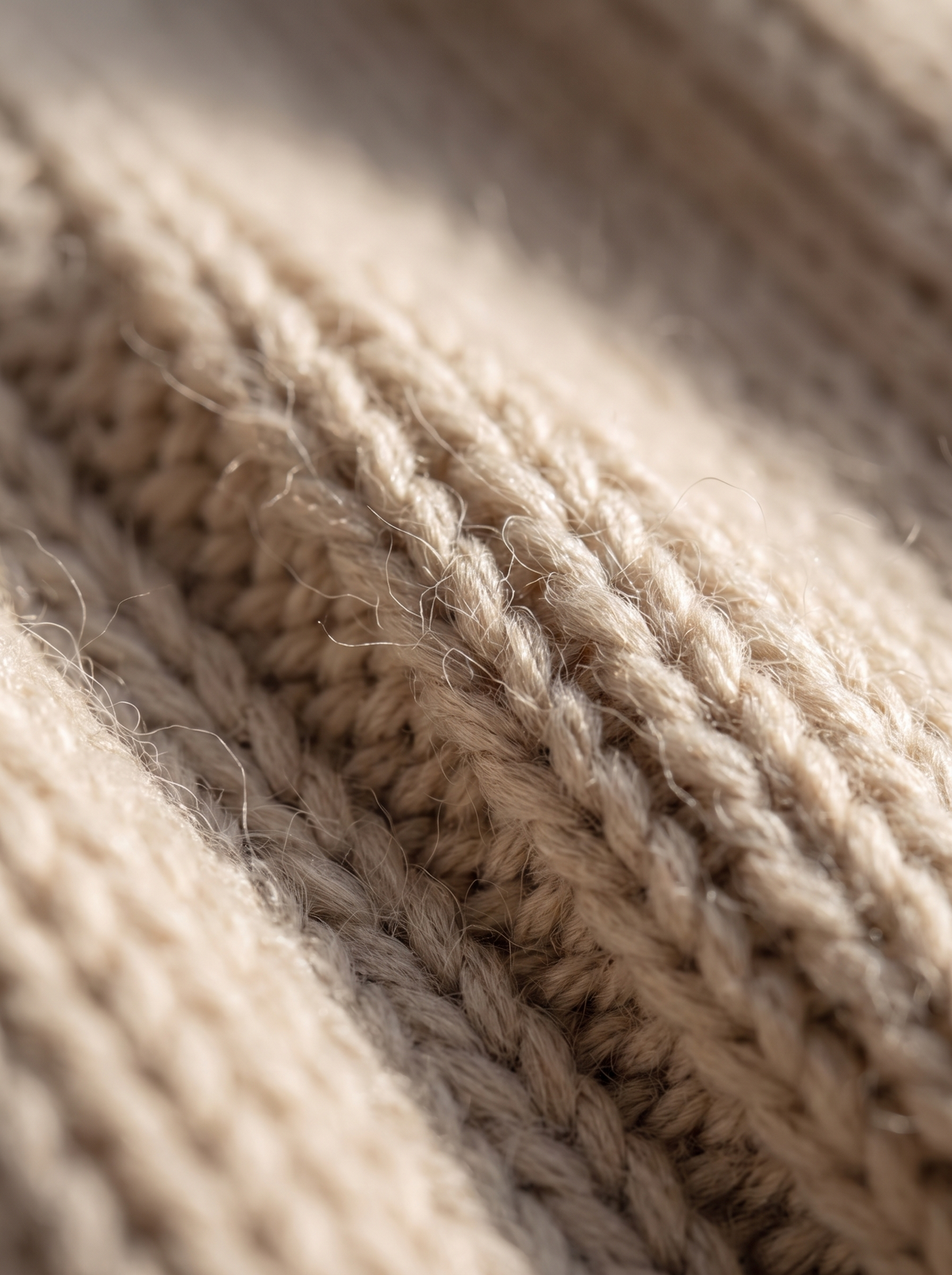 Close up of the fabric of the Aurelia merino wool asymmetric sweater