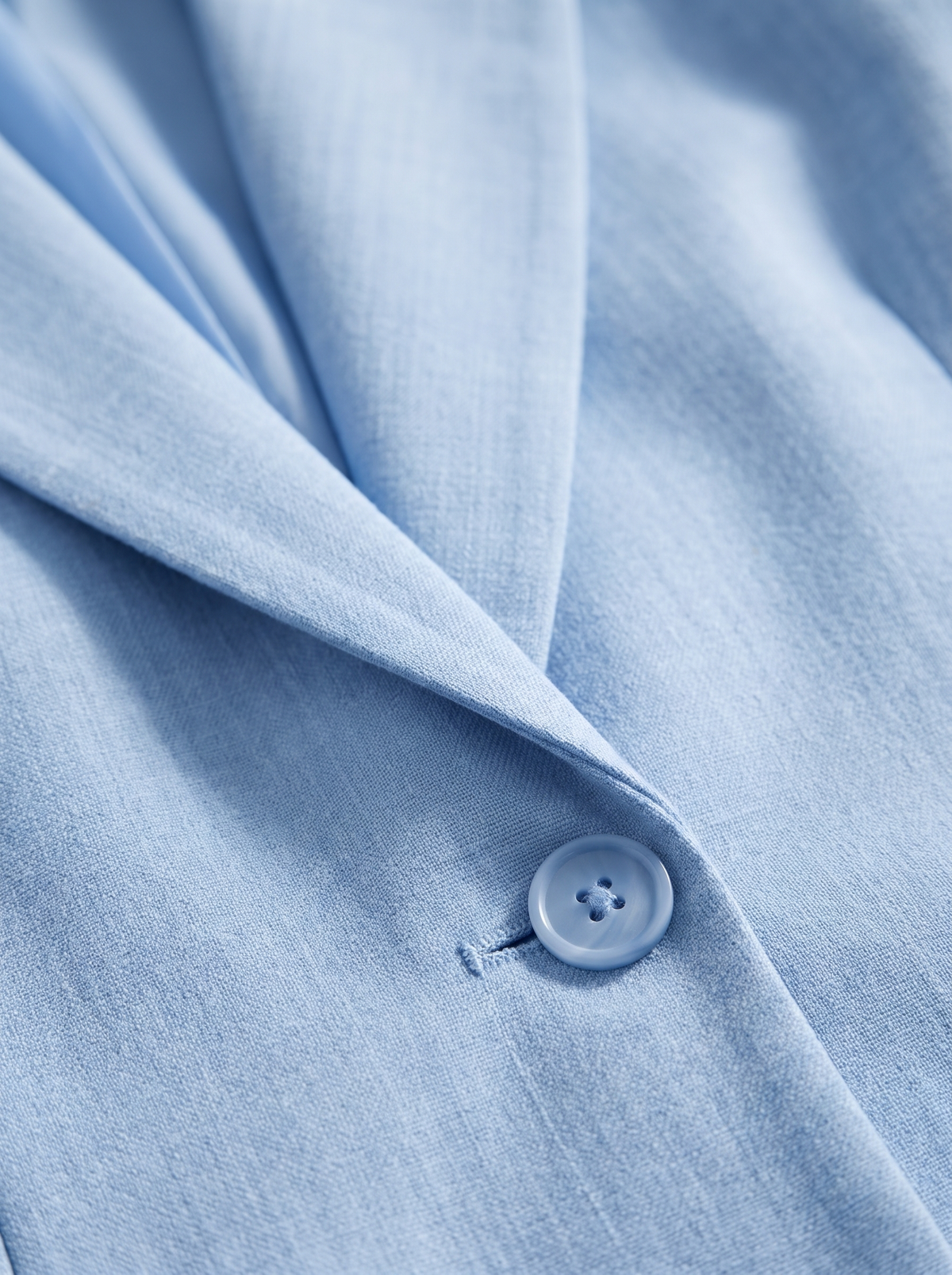 Detail of the Eulalie oversized blazer showing its material and finish