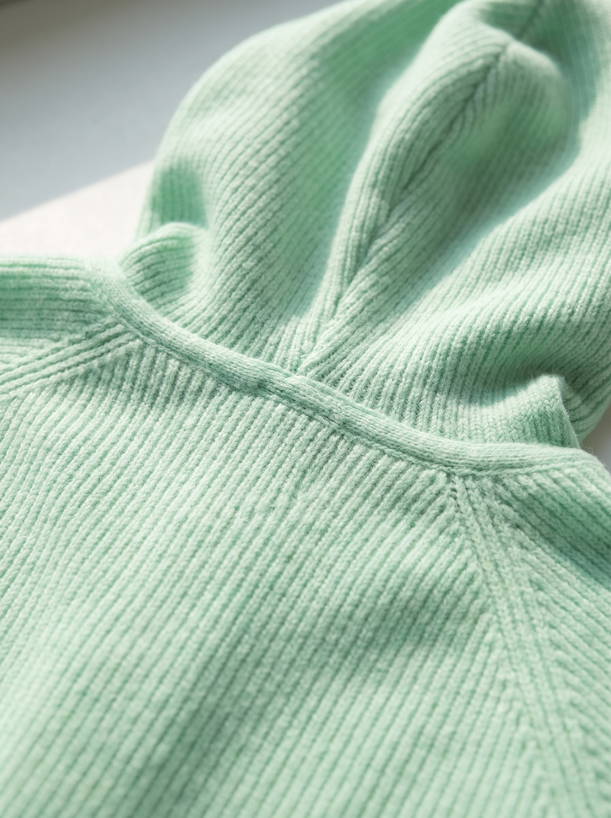Detail of the Bellamy hooded cardigan showing its material and finish