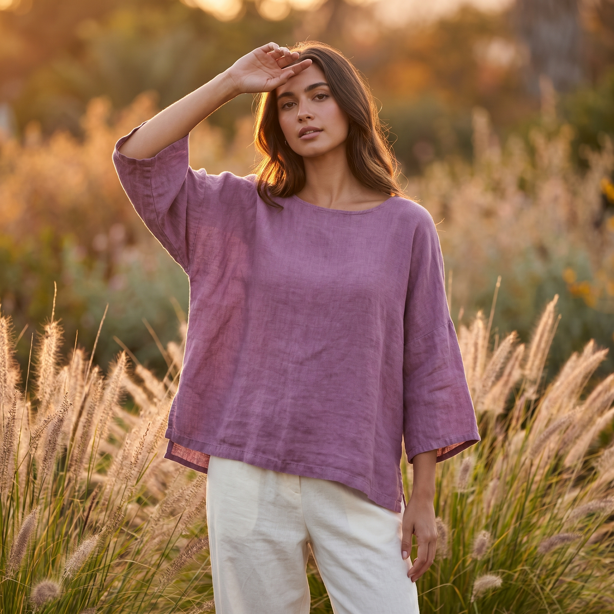 Woman in a garden at golden hour wearing the Purple linen blouse