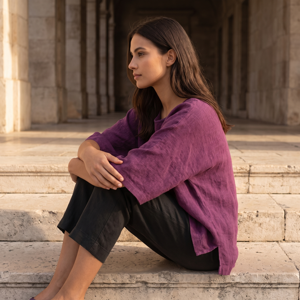 Woman on stone steps wearing the Purple linen blouse