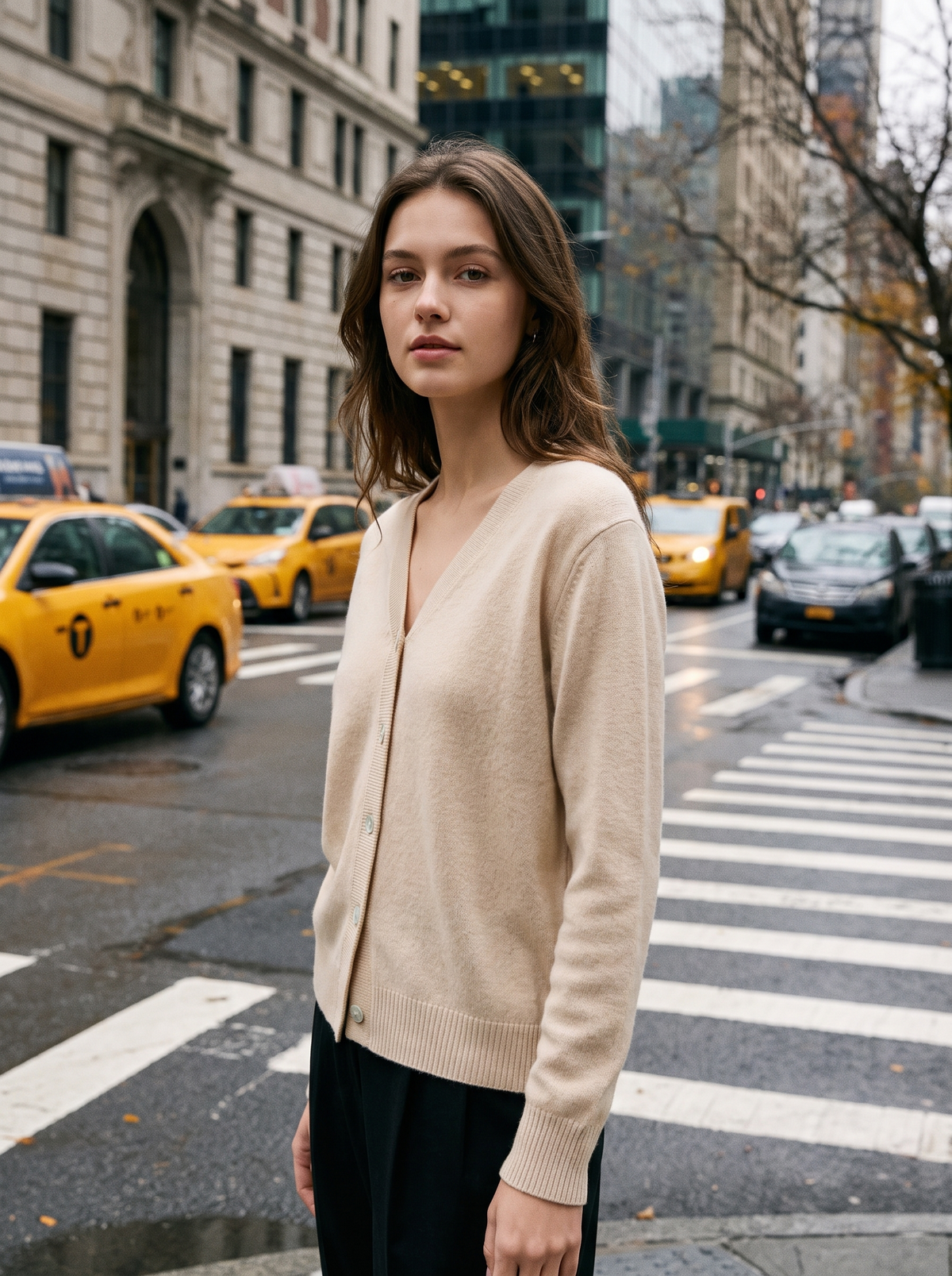 Henriette beige v neck cardigan worn by a model at a city crosswalk in autumn
