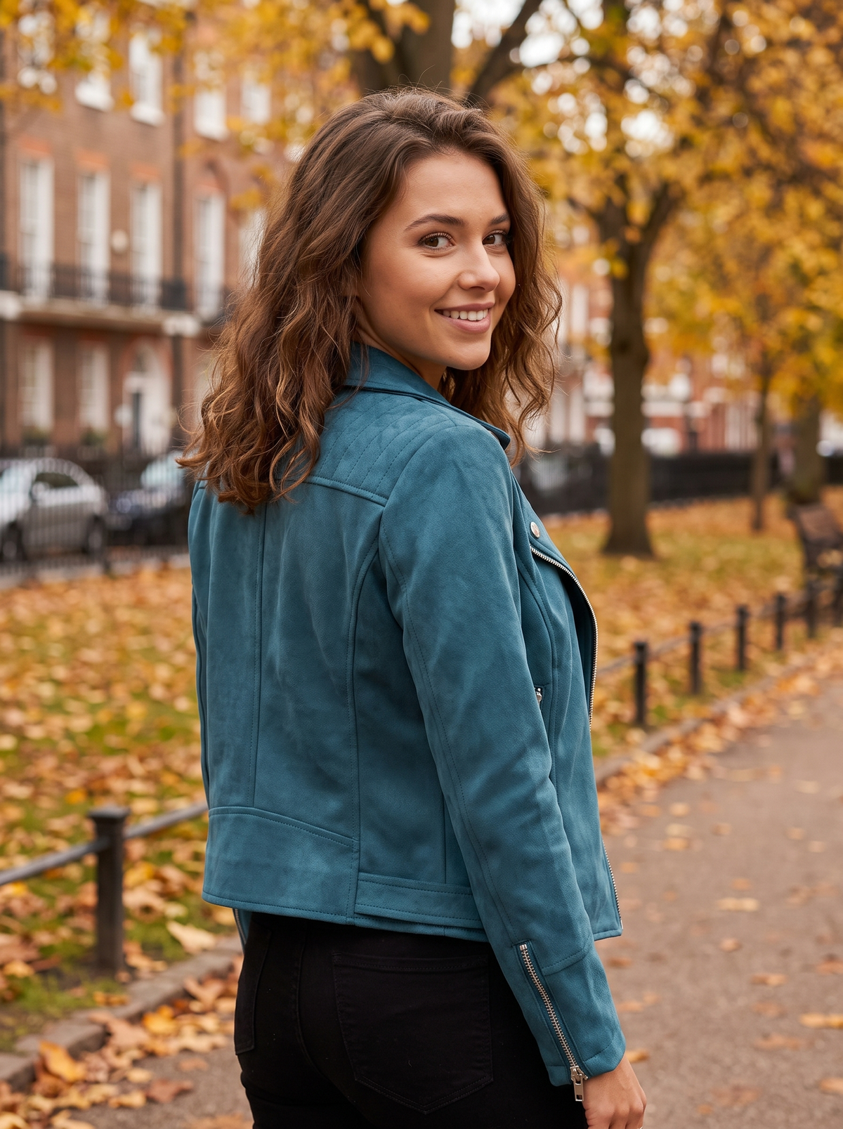 Romilly blue suede moto jacket worn by a model on an autumn park path in autumn