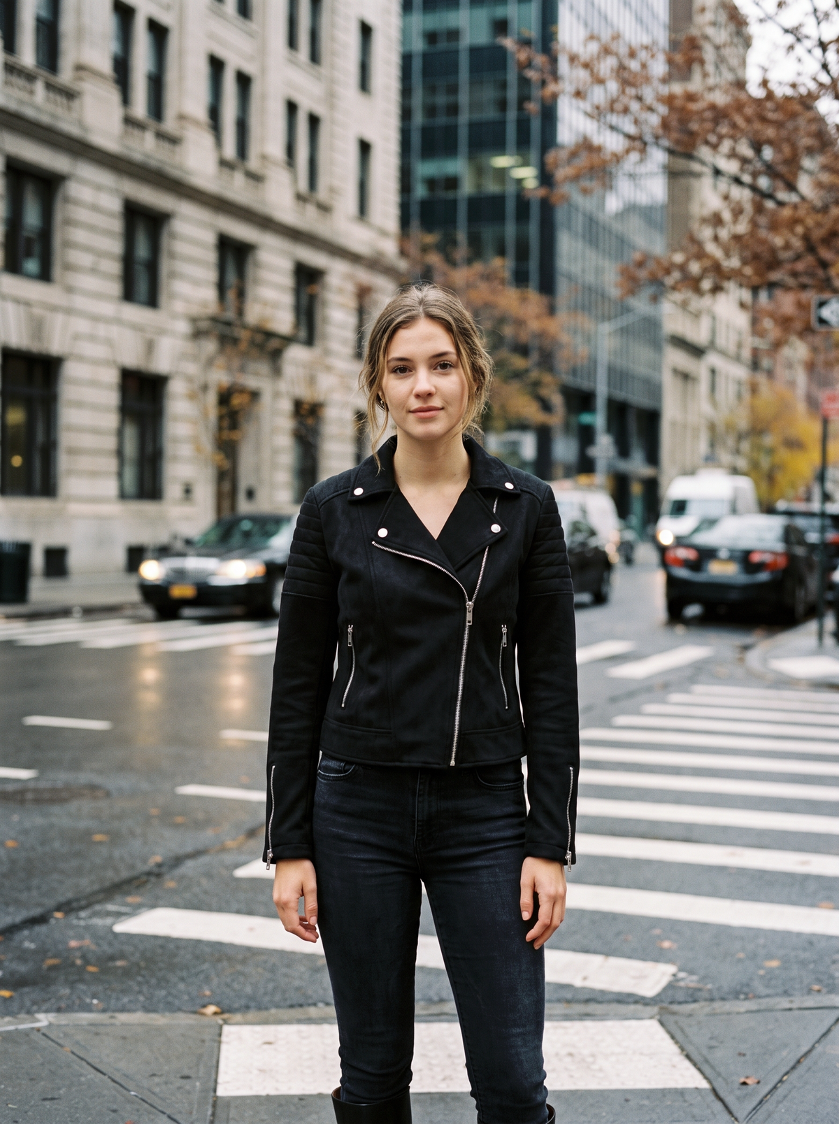 Romilly black suede moto jacket worn by a model at a city crosswalk in autumn