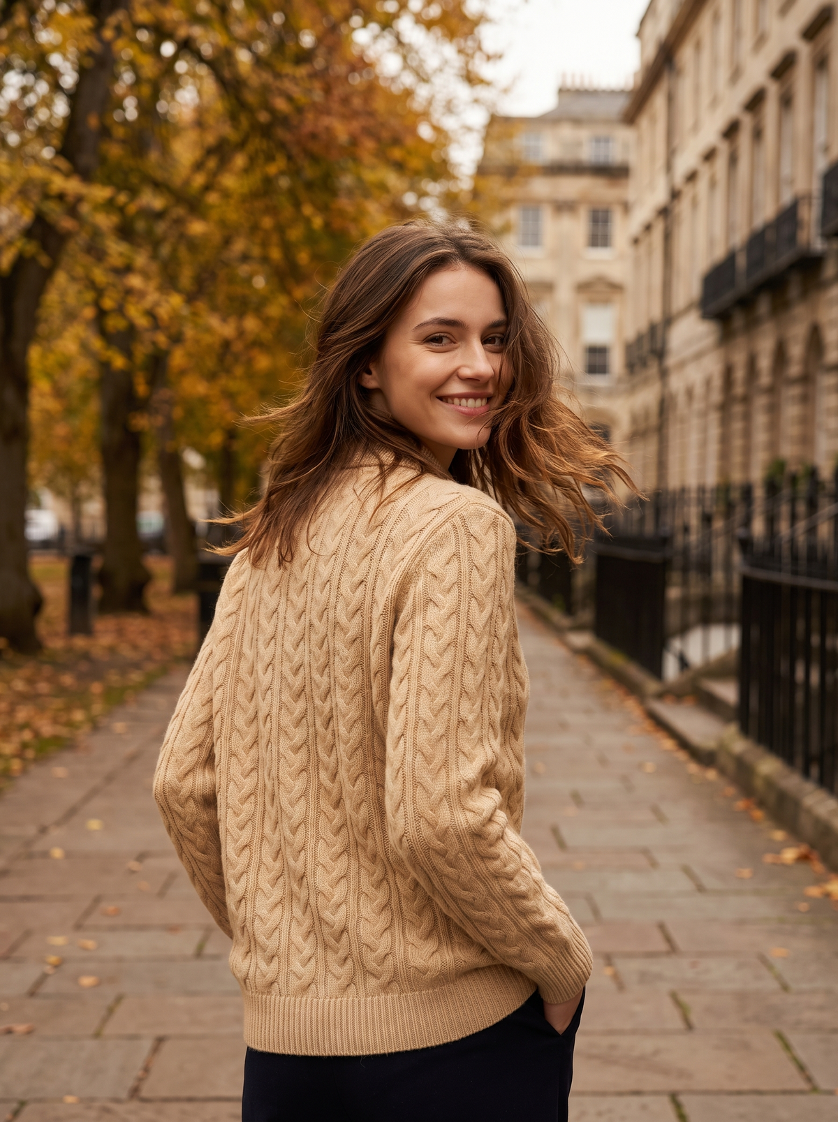Lavinia khaki cable knit sweater worn by a model on an autumn park path in autumn