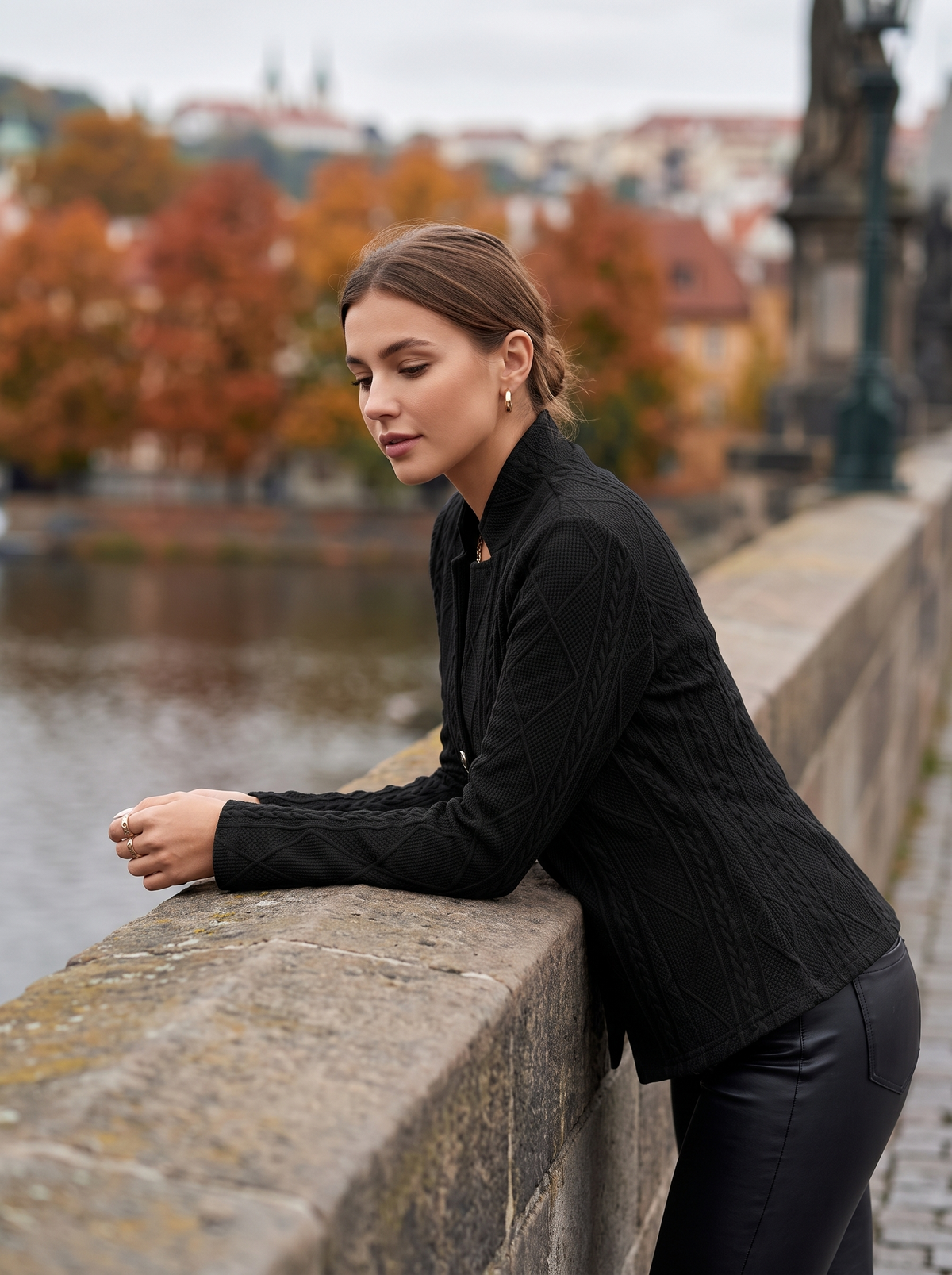 Octavia black cable knit blazer worn by a model on a city bridge in autumn