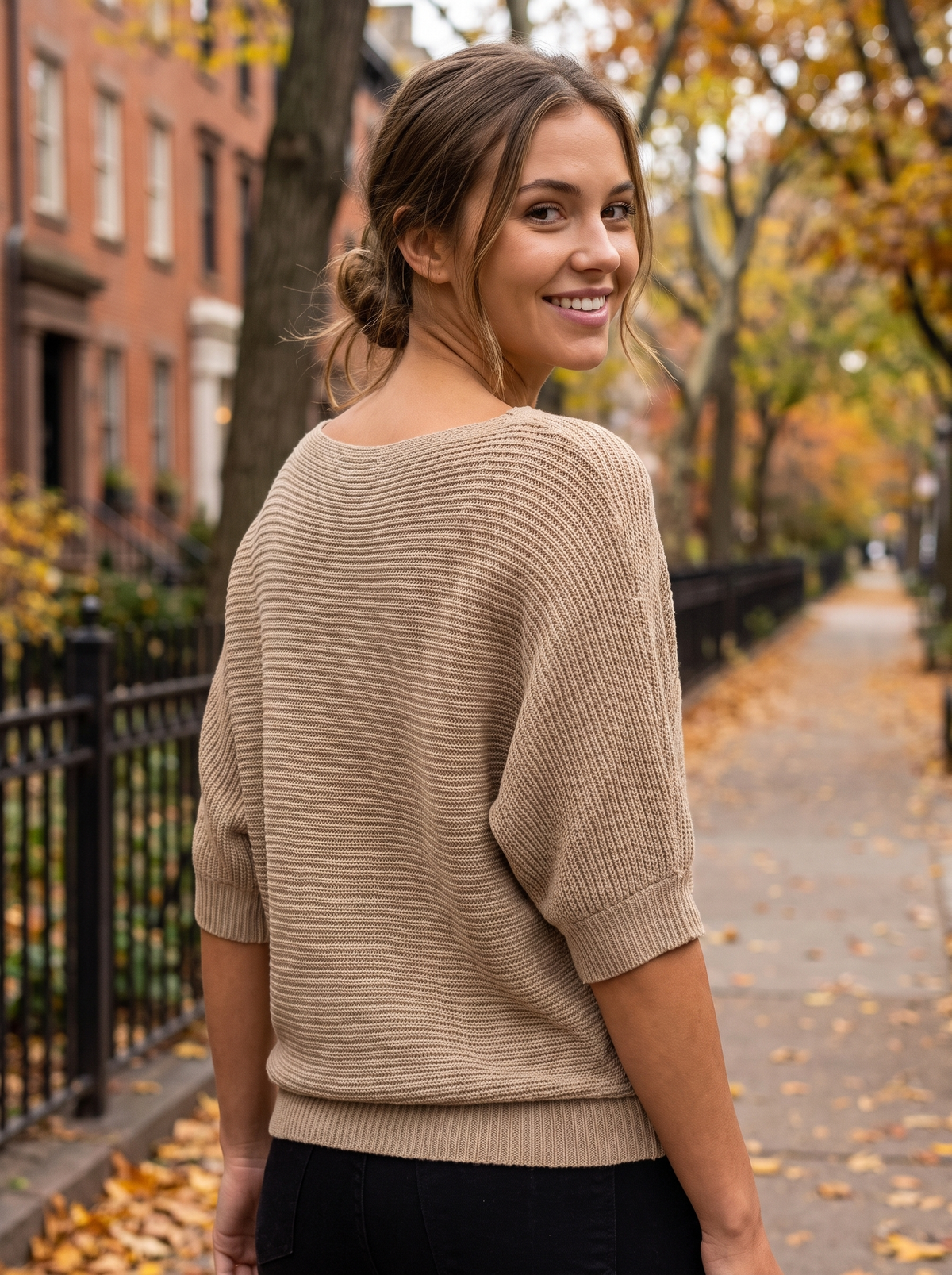 Giselle khaki three quarter sleeve knit sweater worn by a model on an autumn park path in autumn