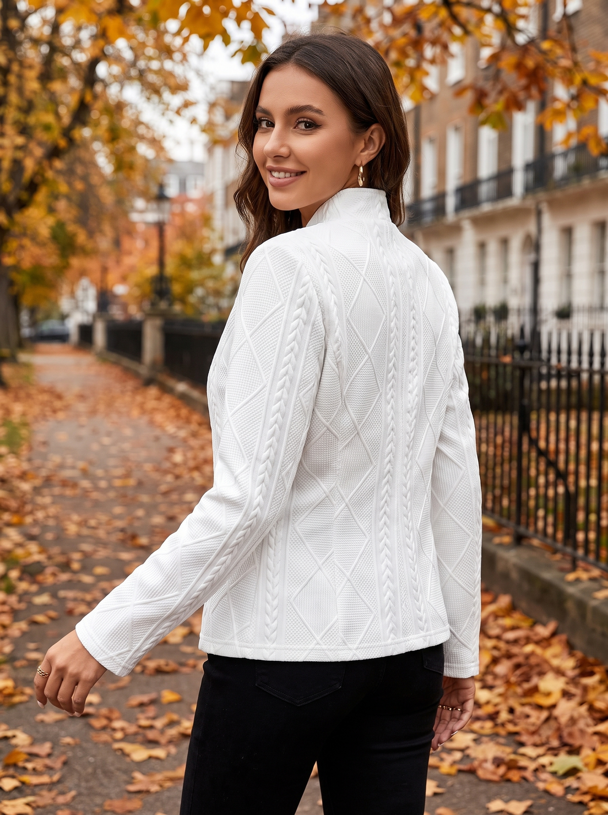 Octavia white cable knit blazer worn by a model on an autumn park path in autumn