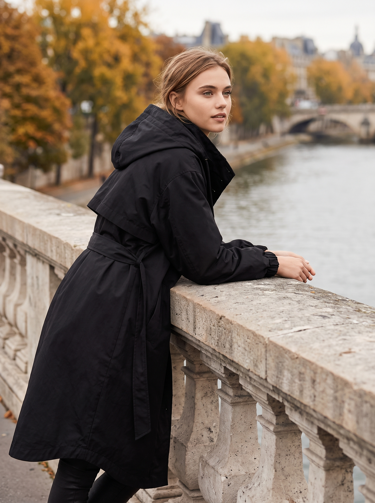 Mirabelle black oversized trench coat worn by a model on a city bridge in autumn