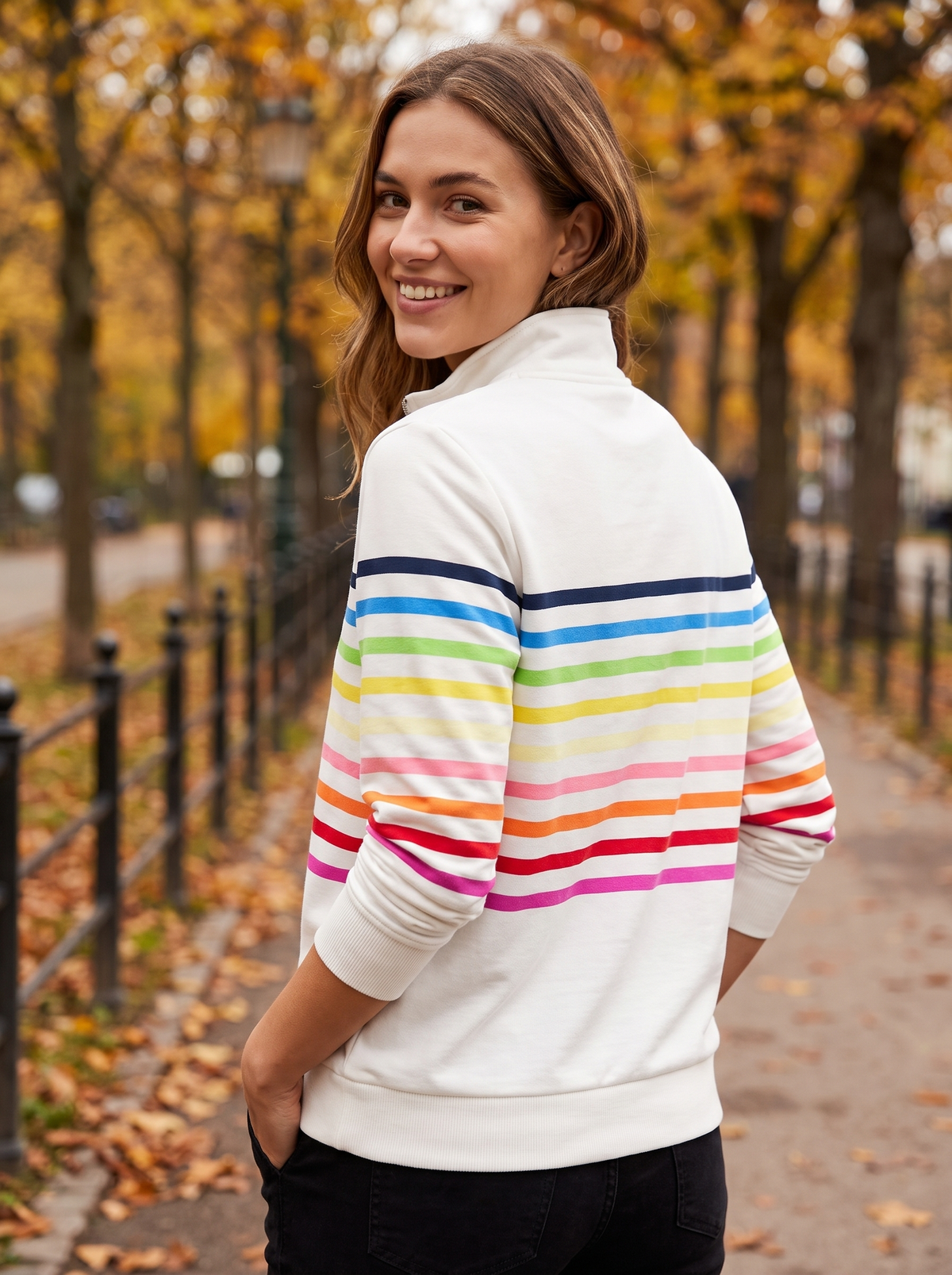 Zephyrine white striped half zip sweatshirt worn by a model on an autumn park path in autumn