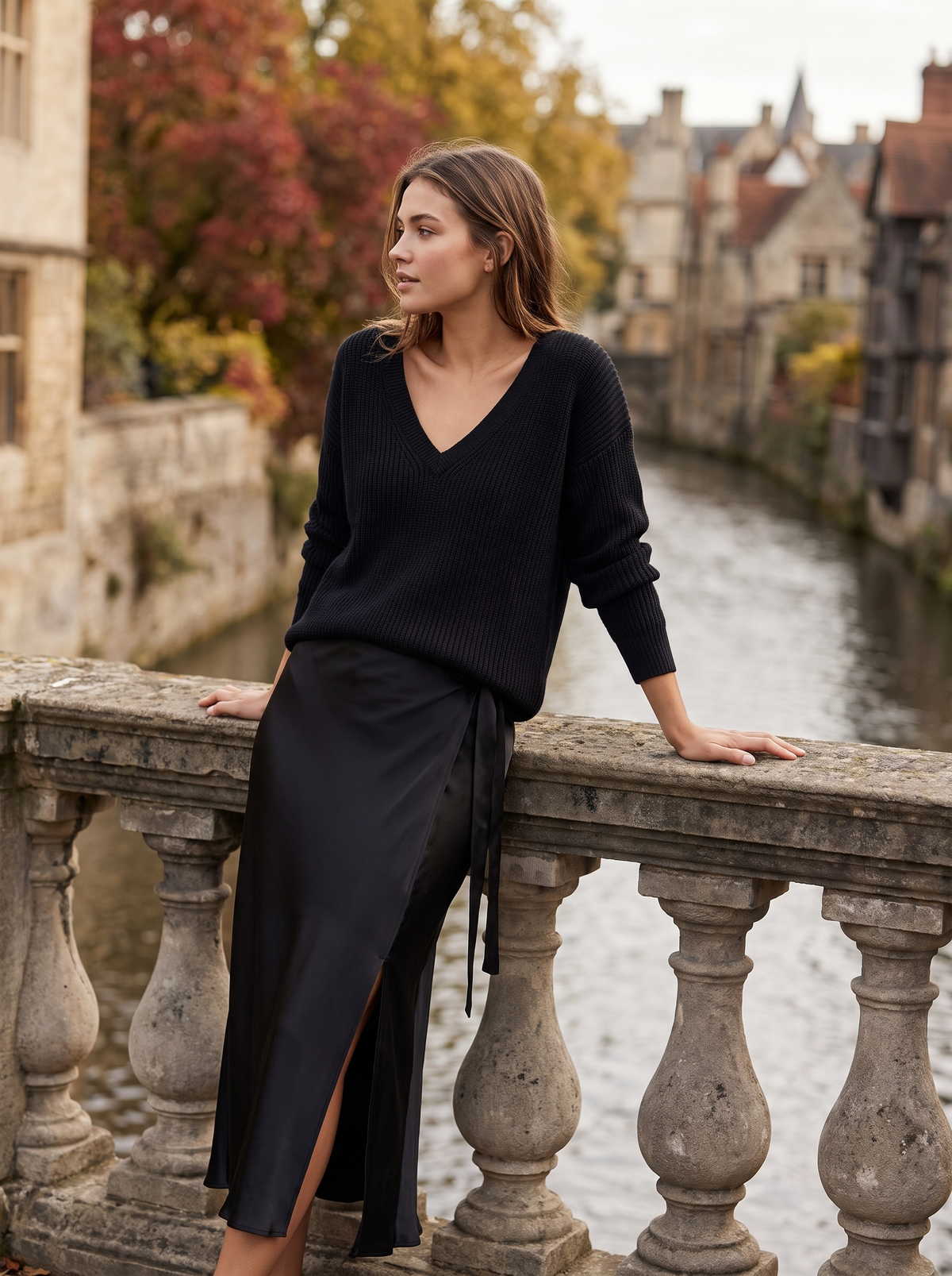 Valentine black knit sweater and satin skirt set worn by a model on a city bridge in autumn