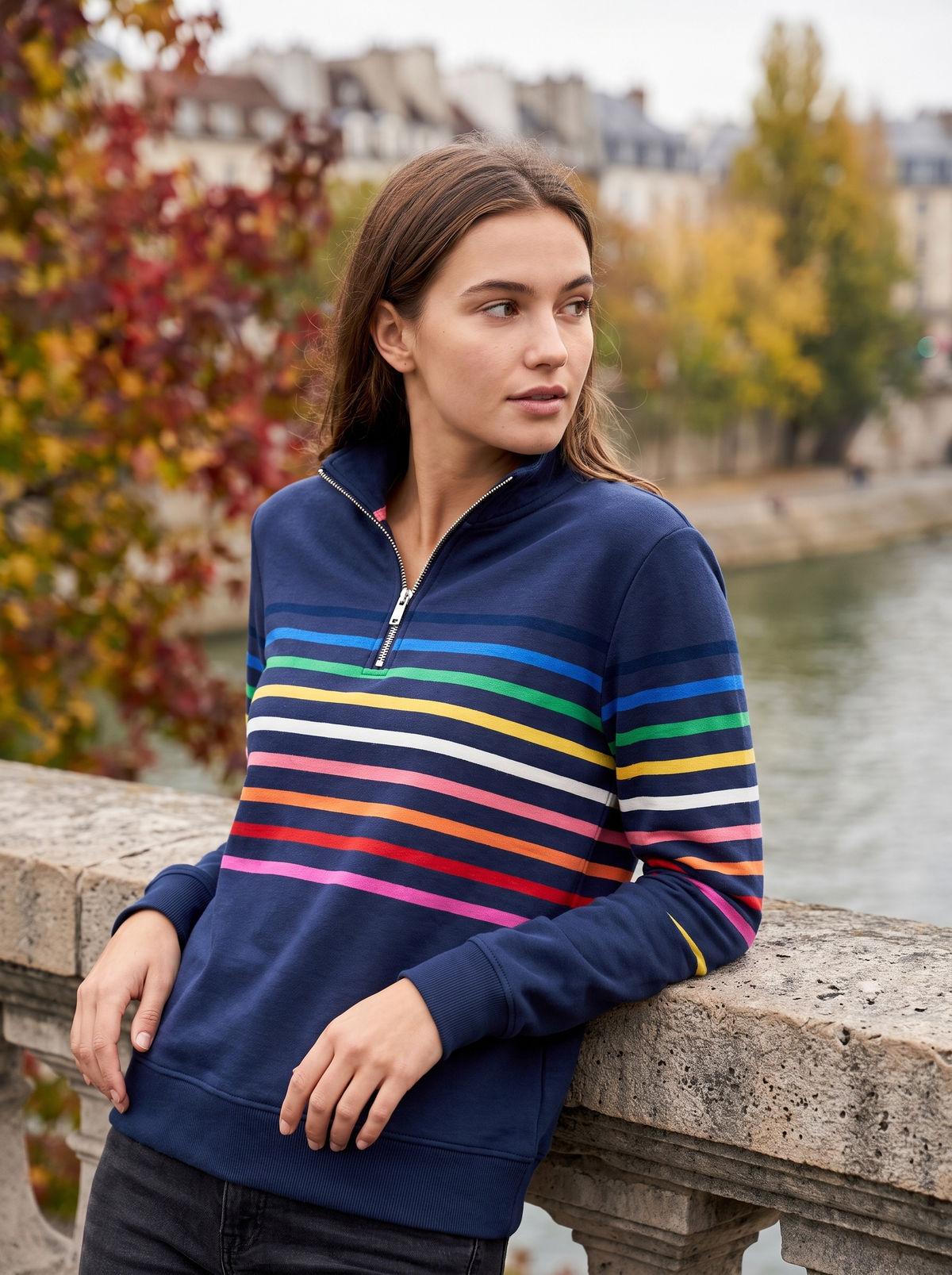 Thomasine navy blue half zip sweatshirt worn by a model on a city bridge in autumn