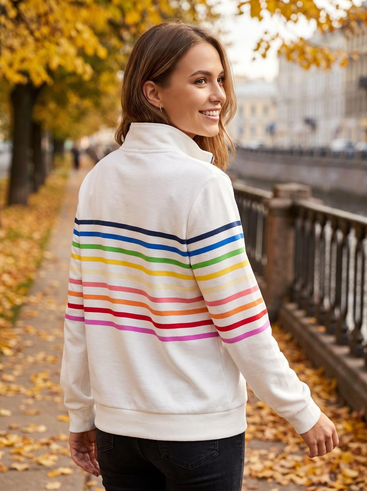 Thomasine white half zip sweatshirt worn by a model on an autumn park path in autumn