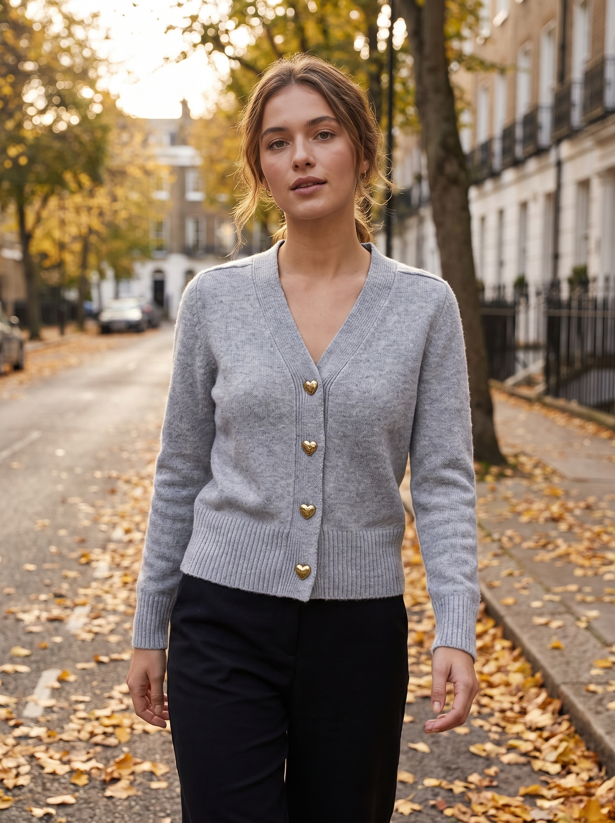 Yolande grey ribbed knit cardigan worn by a model walking a leafy city street in autumn