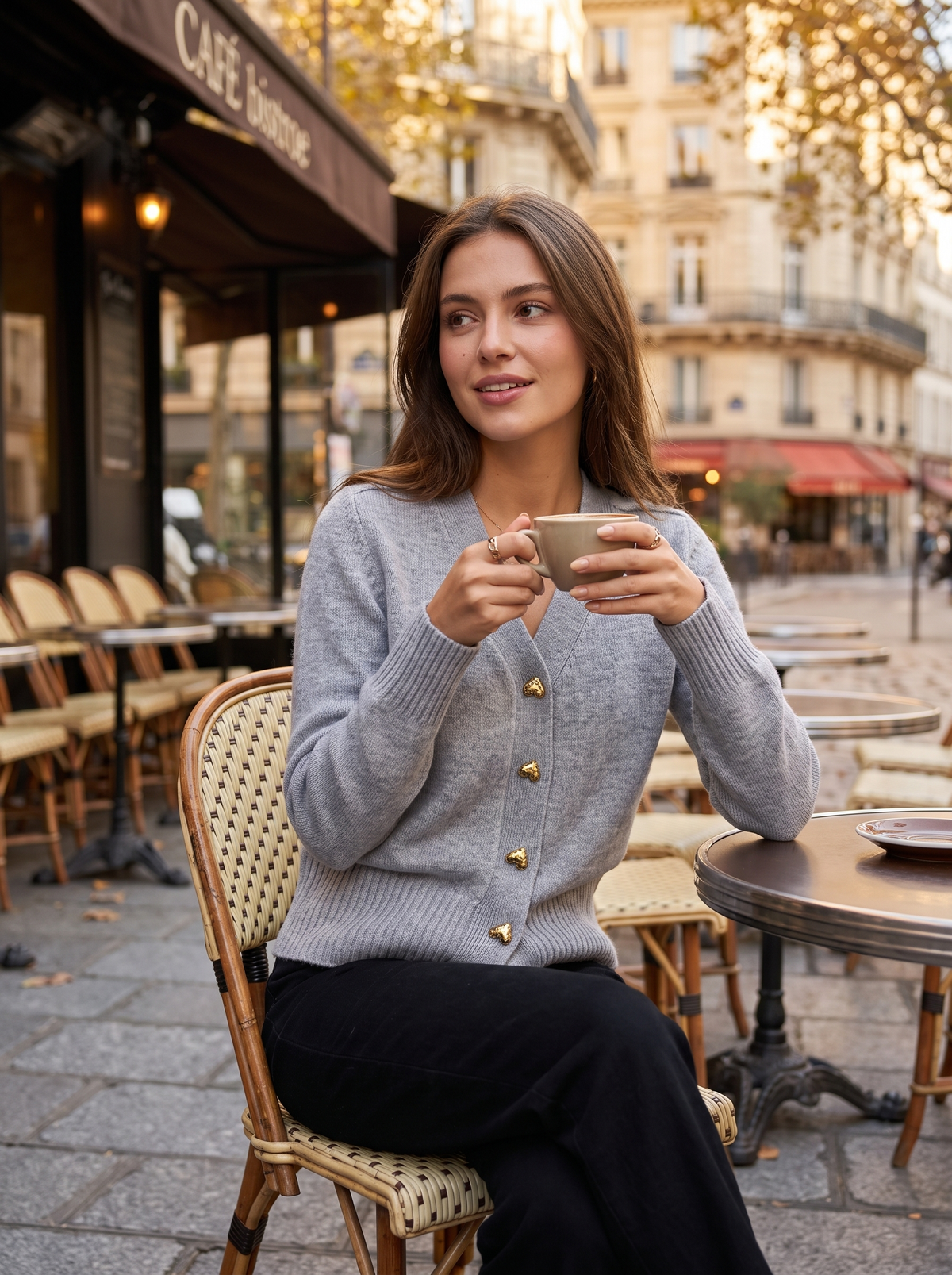 Yolande grey ribbed knit cardigan worn by a model at an outdoor city cafe in autumn