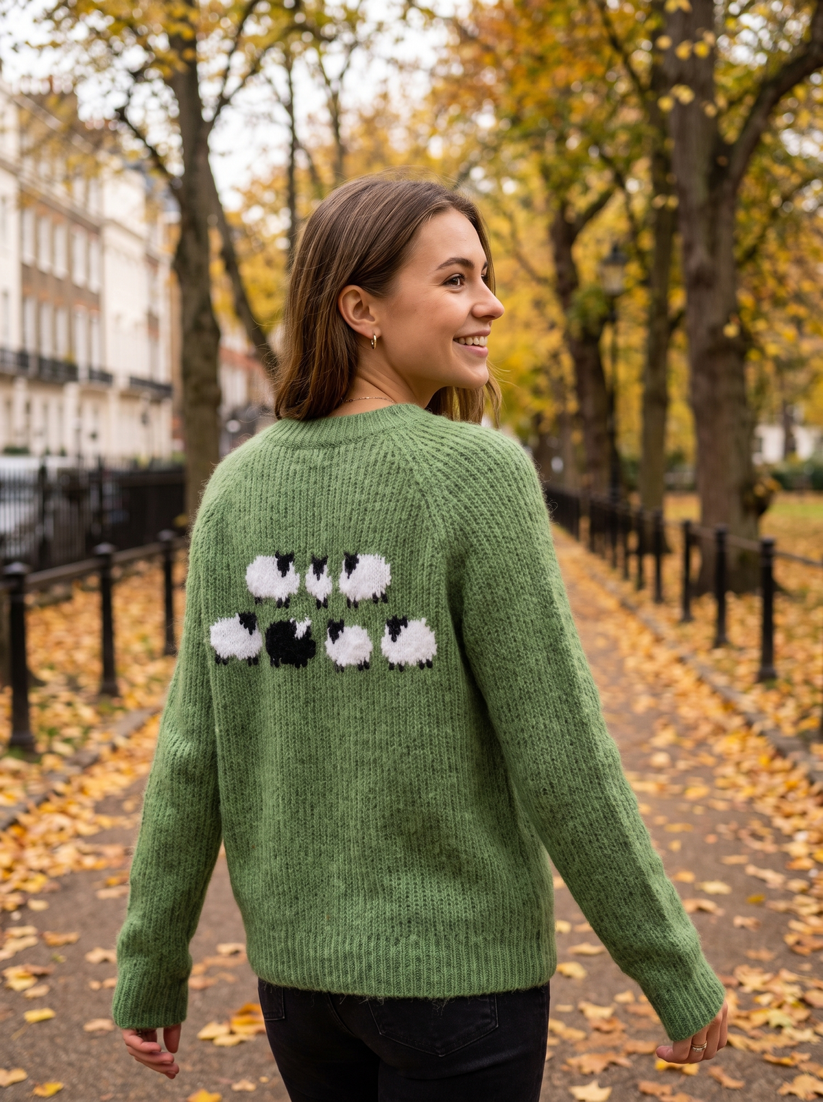 Vespera green crew neck knit sweater worn by a model on an autumn park path in autumn