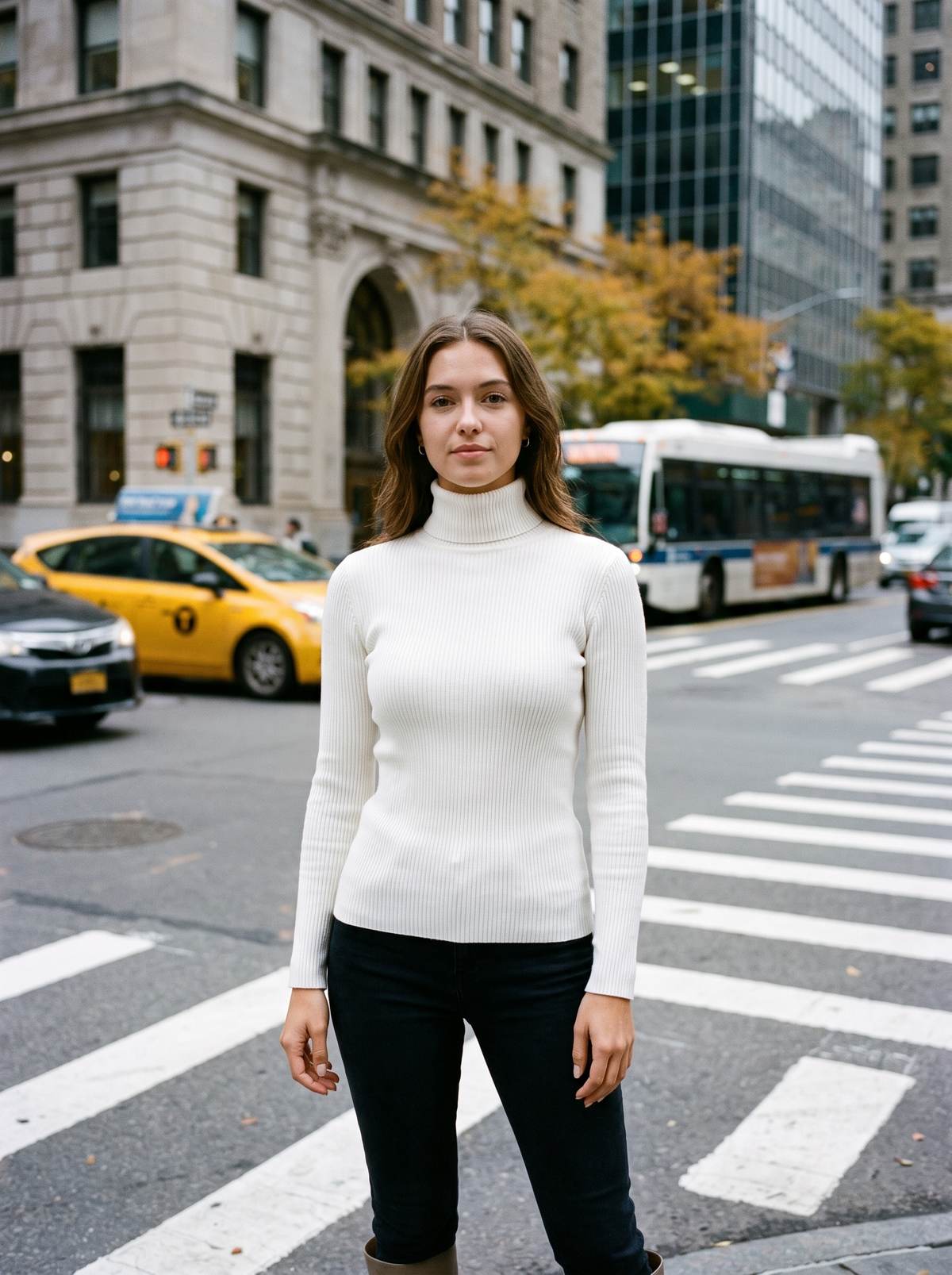 Clarisse white roll neck ribbed sweater worn by a model at a city crosswalk in autumn
