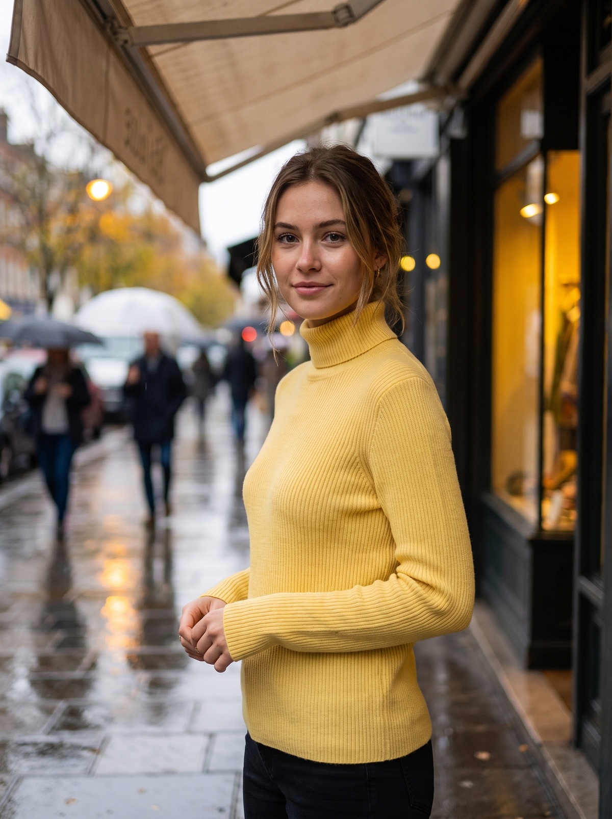 Clarisse yellow roll neck ribbed sweater worn by a model under a shop awning in the rain in autumn