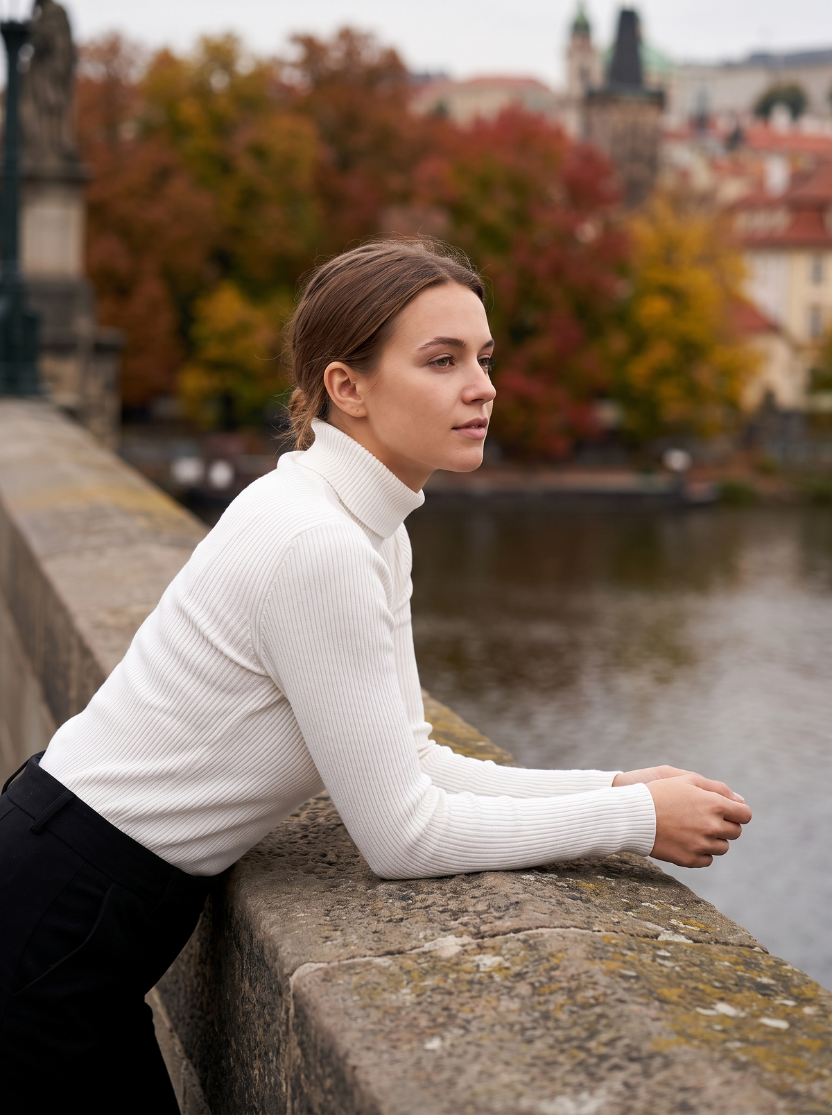 Clarisse white roll neck ribbed sweater worn by a model on a city bridge in autumn