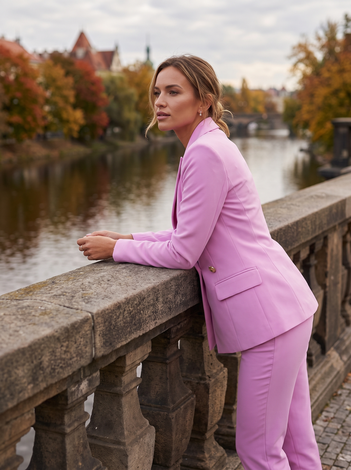 Xaviera pink double breasted blazer suit set worn by a model on a city bridge in autumn