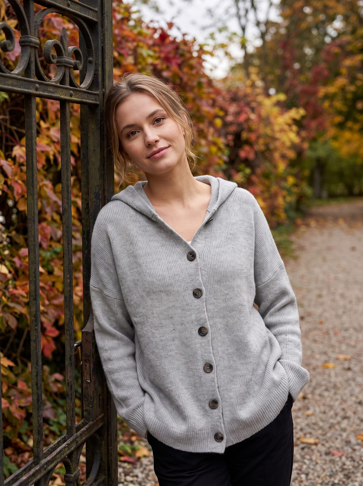 Bellamy grey hooded cardigan worn by a model at a park gate in autumn
