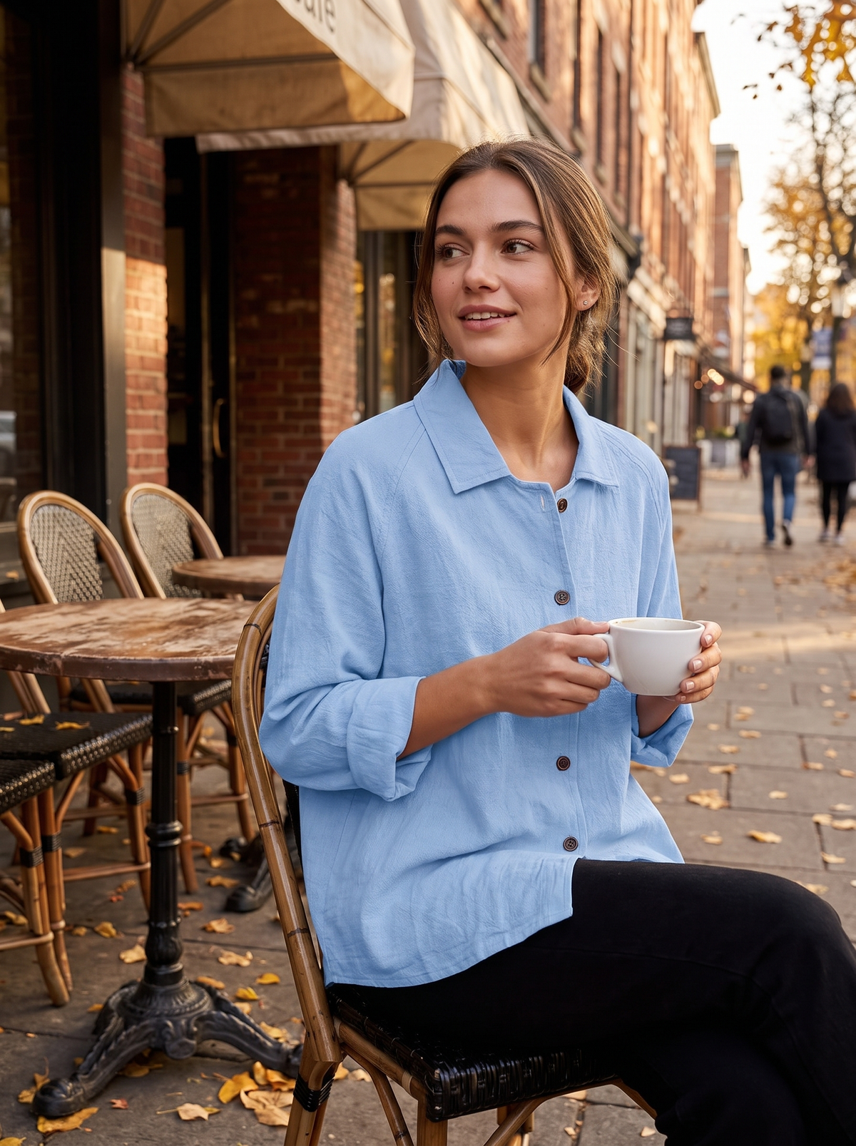 Eulalie light blue oversized blazer worn by a model at an outdoor city cafe in autumn