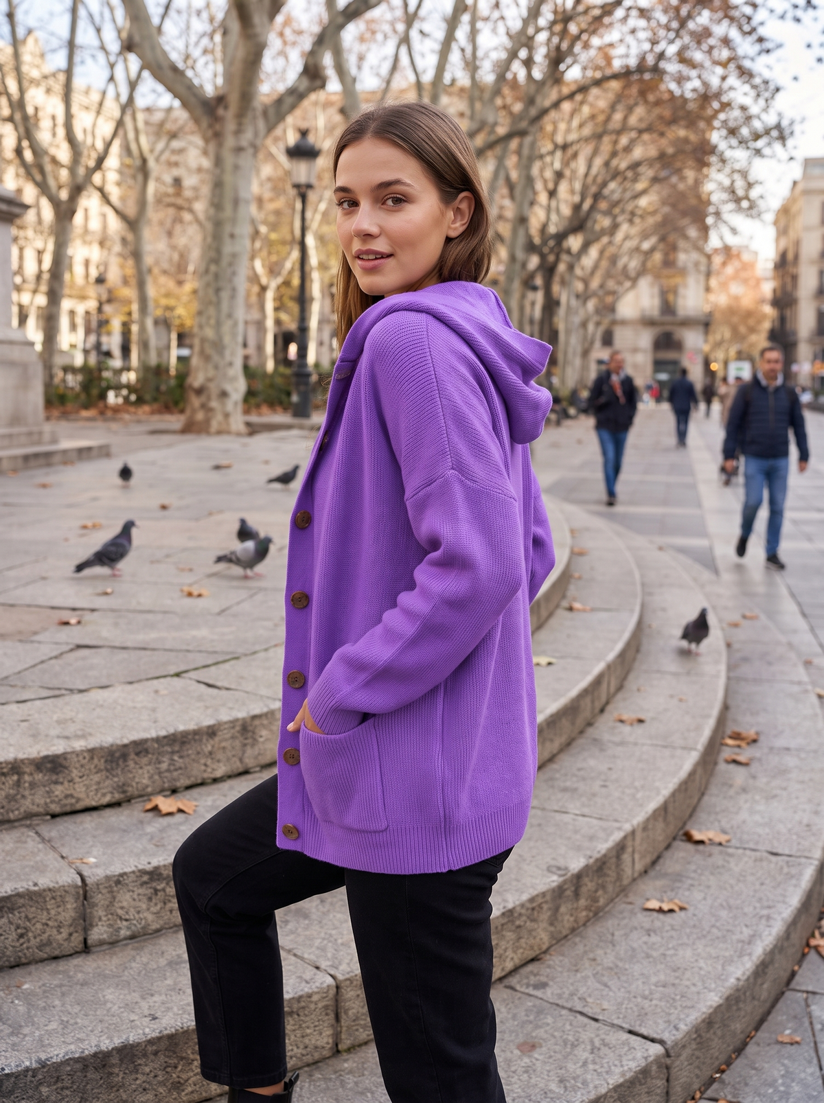 Bellamy purple hooded cardigan worn by a model on city plaza steps in autumn