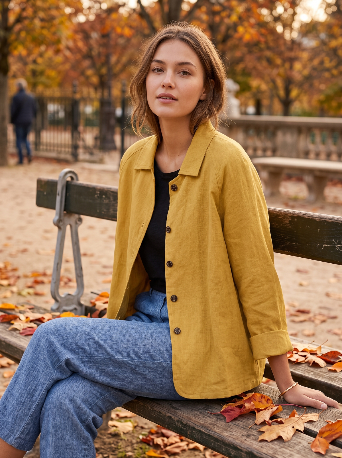 Eulalie yellow oversized blazer worn by a model on an autumn park bench in autumn