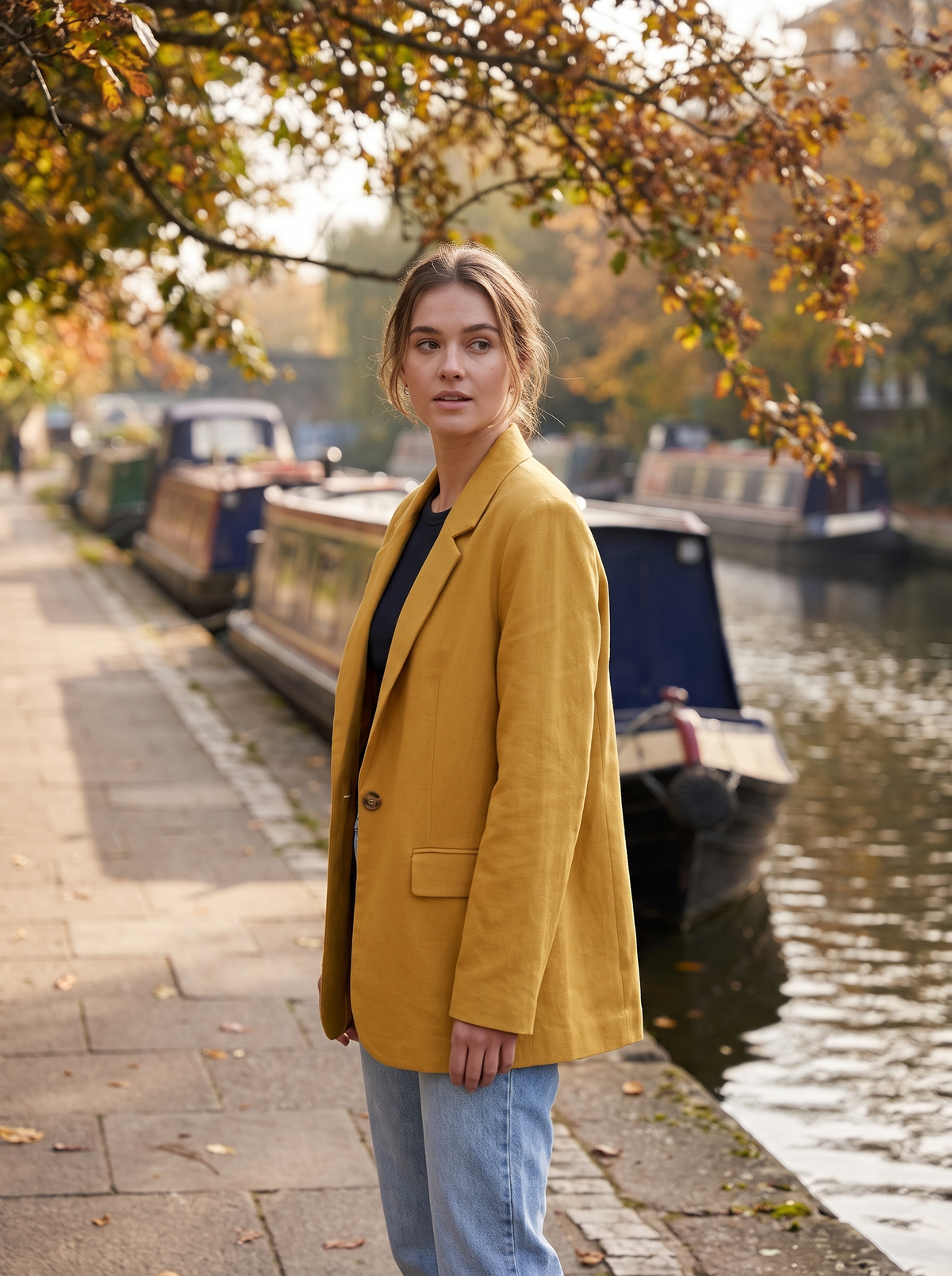 Eulalie yellow oversized blazer worn by a model on a city canal towpath in autumn
