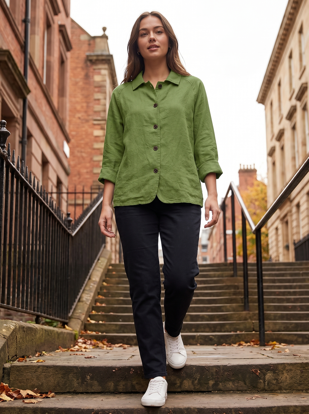 Eulalie green oversized blazer worn by a model on iron railed city steps in autumn