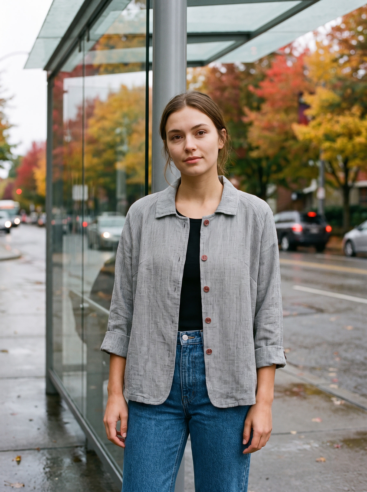 Eulalie light grey oversized blazer worn by a model by a city bus shelter in autumn