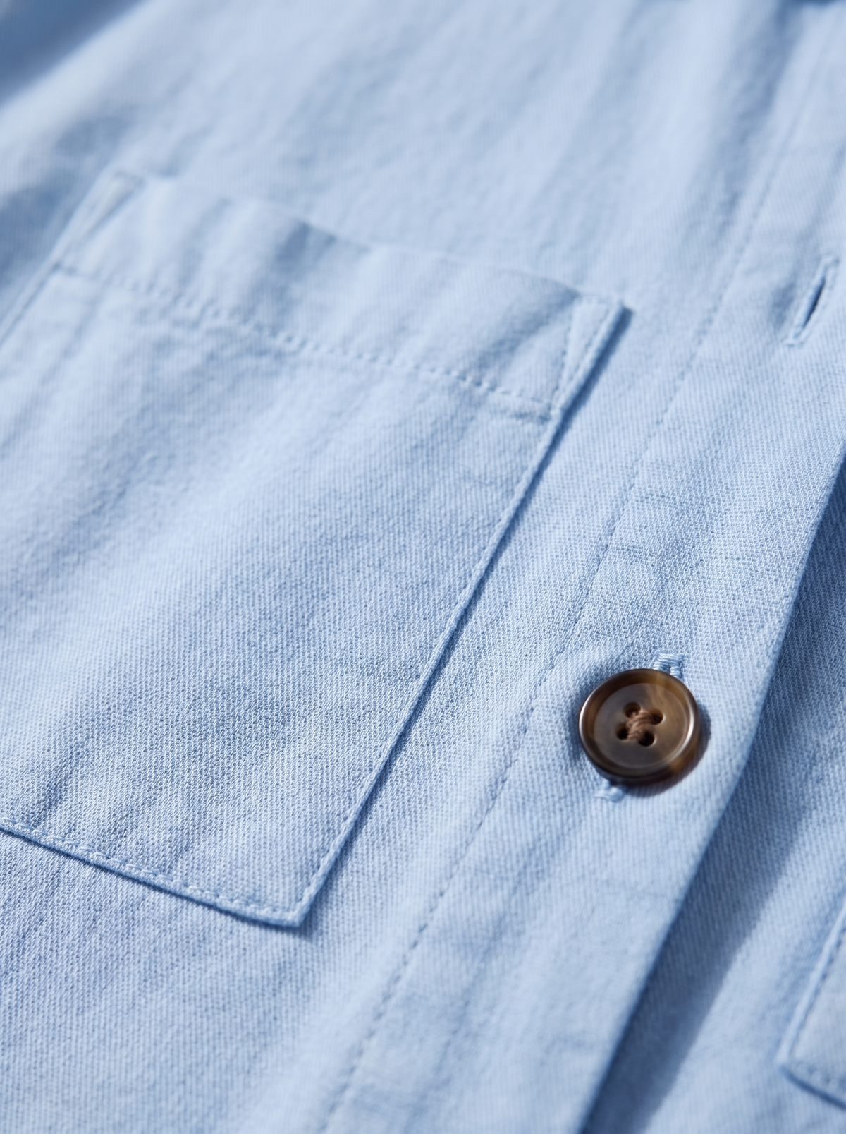 Detail of the Linnea cotton shirt jacket showing its material and finish