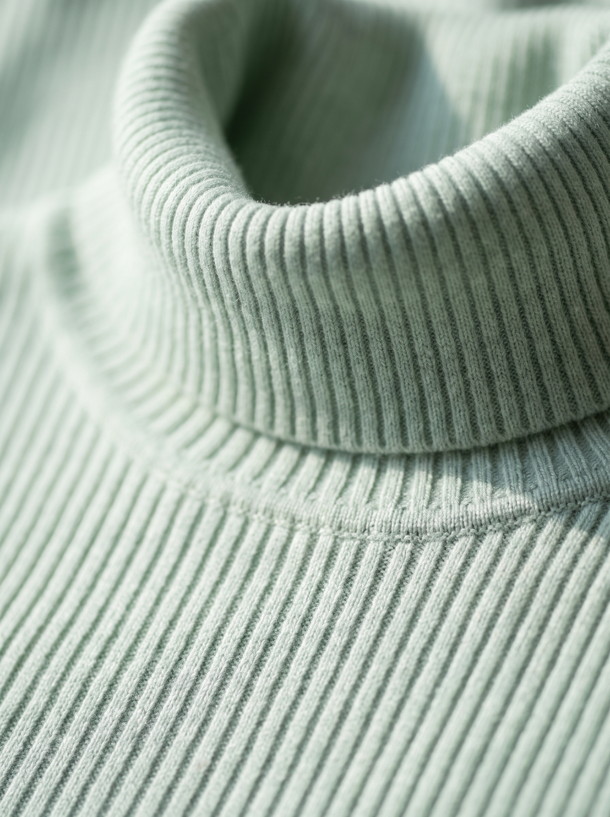 Detail of the Clarisse roll neck ribbed sweater showing its material and finish