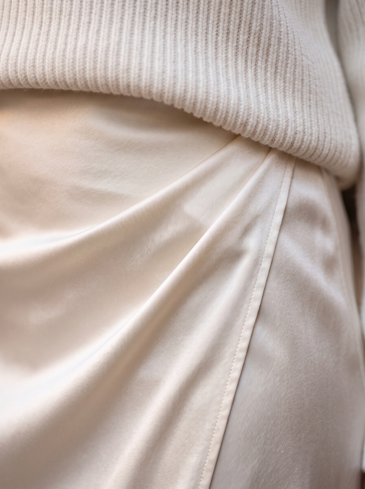 Detail of the Valentine knit sweater and satin skirt set showing its material and finish